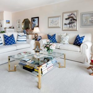 Modern living room with stylish decor and comfortable white sofas.