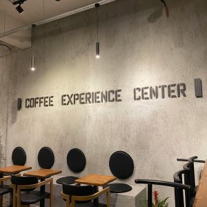 Contemporary café setting with minimalist seating and industrial lighting.