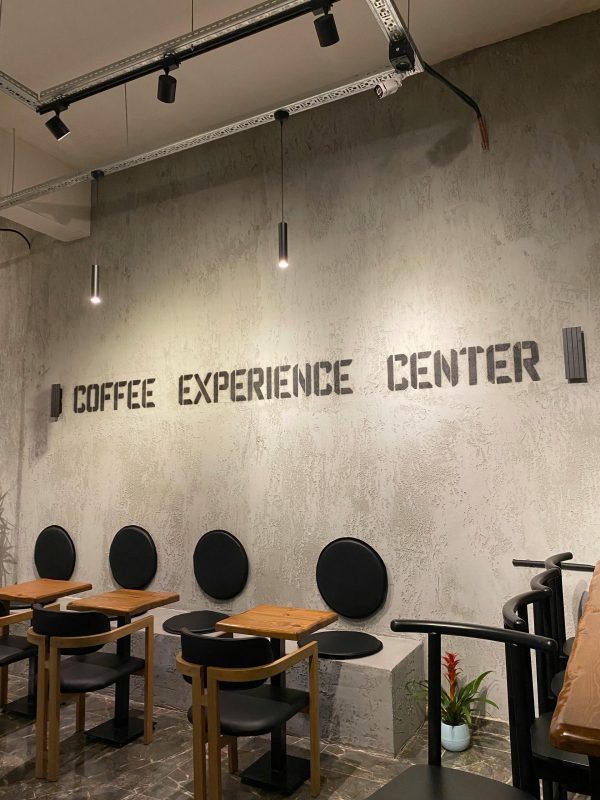 Contemporary café setting with minimalist seating and industrial lighting.