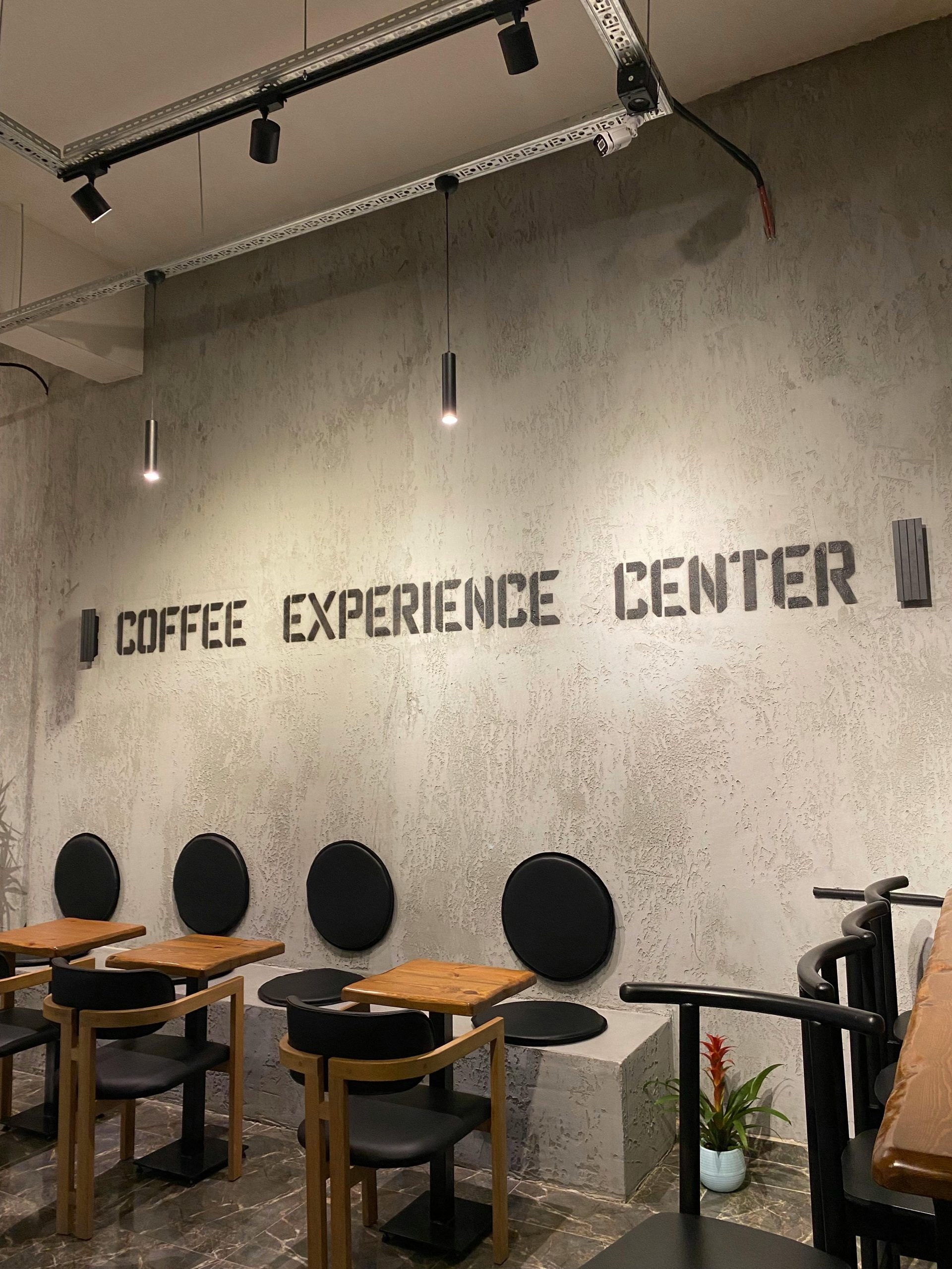 Contemporary café setting with minimalist seating and industrial lighting.